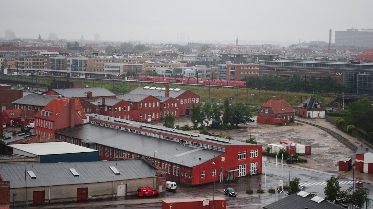 Overcast sky above industrial buildings and city skyline