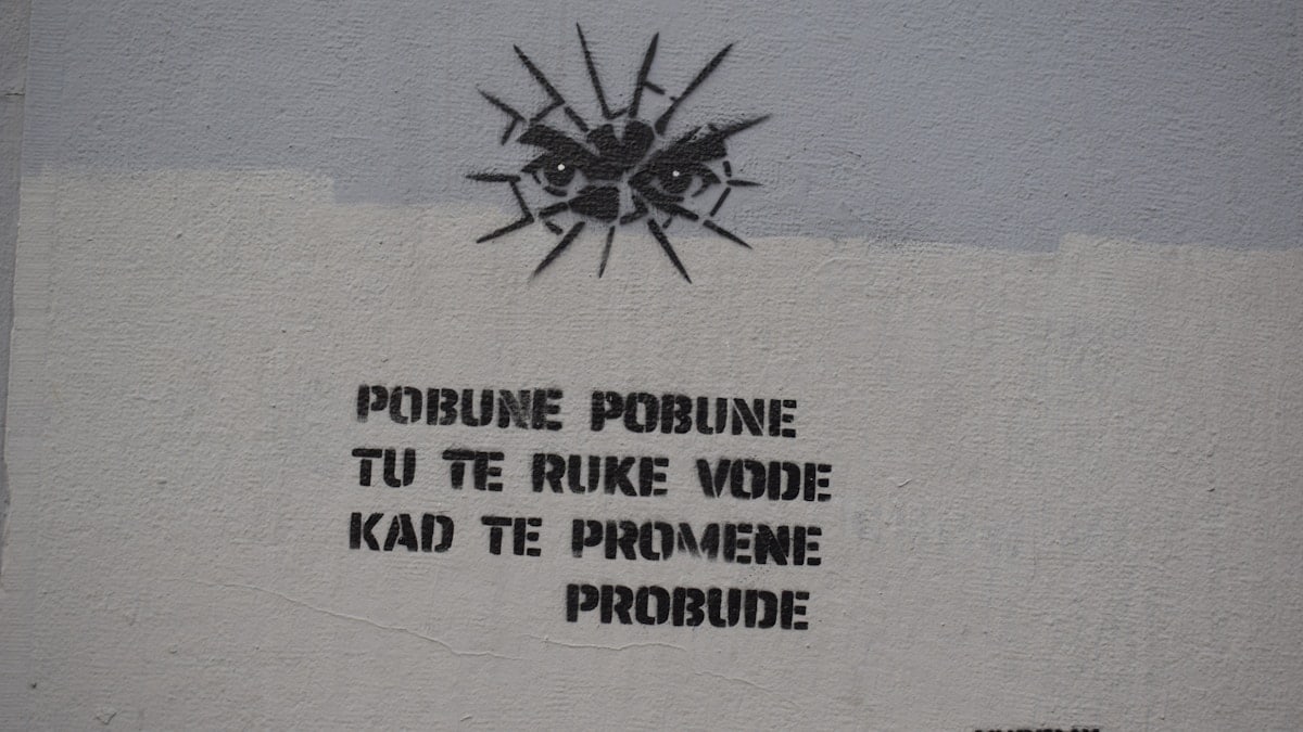 Graffiti with eyes and text on a wall